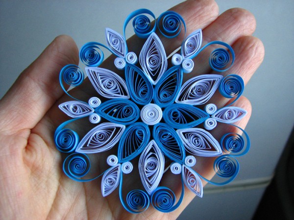 Snowflake for decorating a window for the New Year using the quilling technique